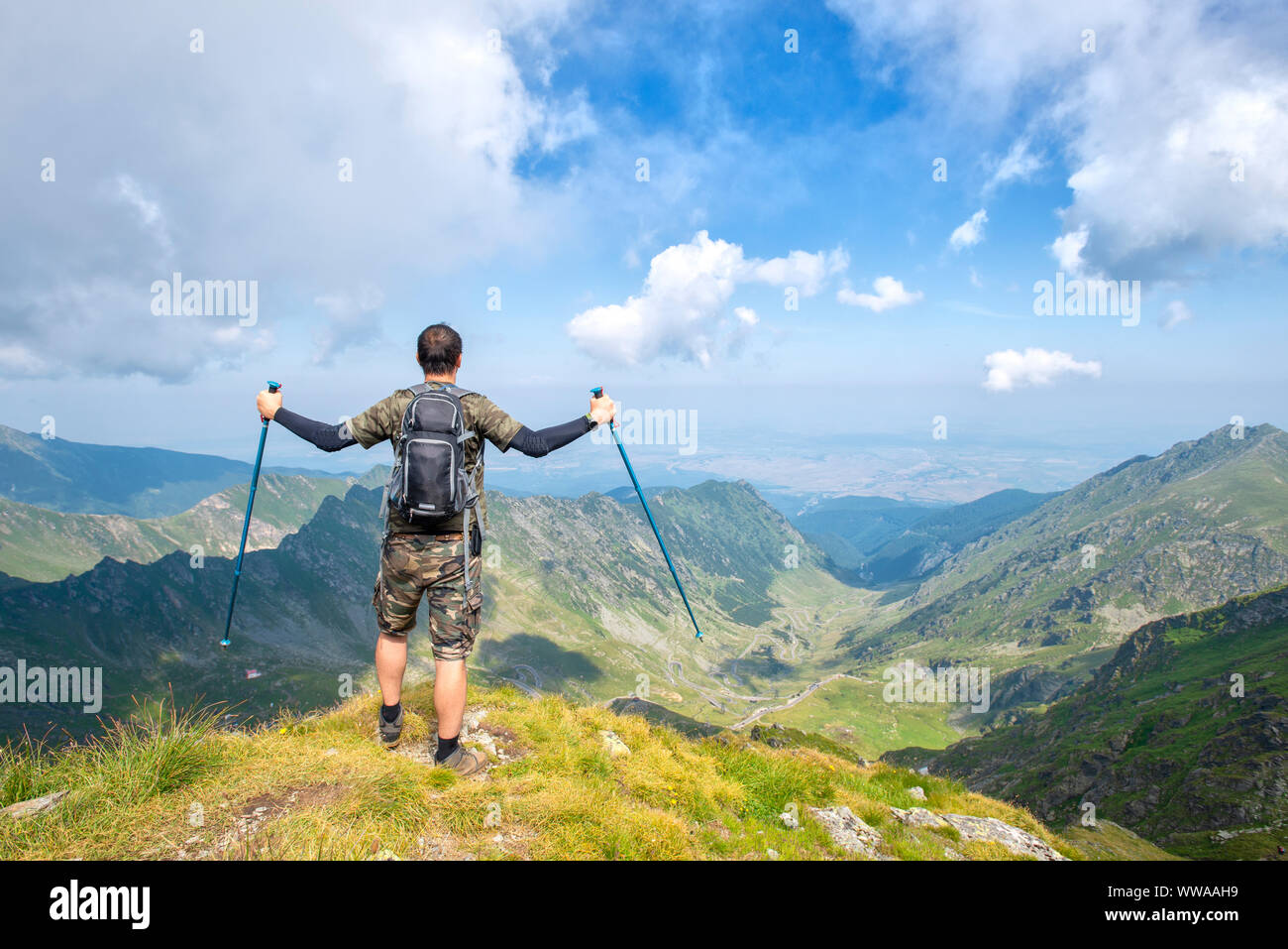 Successful active man hiker on top of mountain enjoying the view. Travel sport lifestyle concept Stock Photo