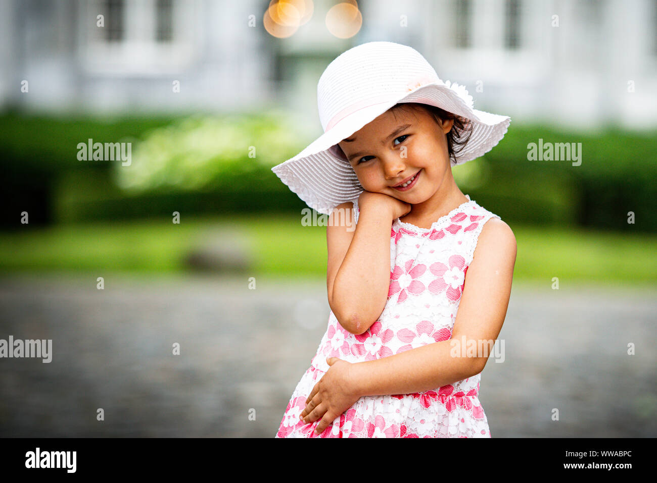Portrait of little girl smilling at camera Stock Photo - Alamy