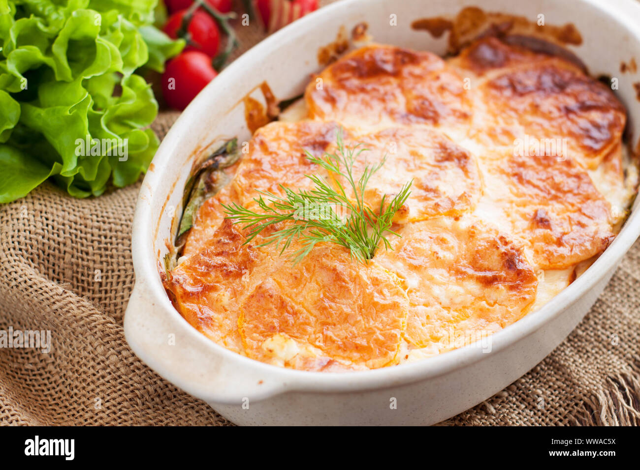 Healthy casserole or gratin with sweet potatoes, spinach, eggs and feta