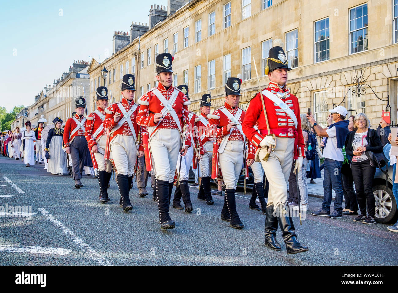 Bath, Somerset, UK. 14th Sep, 2019. Members of the re-enactment group, His Majesty's 33rd Regiment of Foot are pictured marching along Great Pulteney Street as they take part in the world famous Grand Regency Costumed Promenade. The Promenade, part of the 10 day Jane Austen Festival is a procession through the streets of Bath and the participants who come from all over the world dress in 18th Century costume. Credit: lynchpics/Alamy Live News Stock Photo