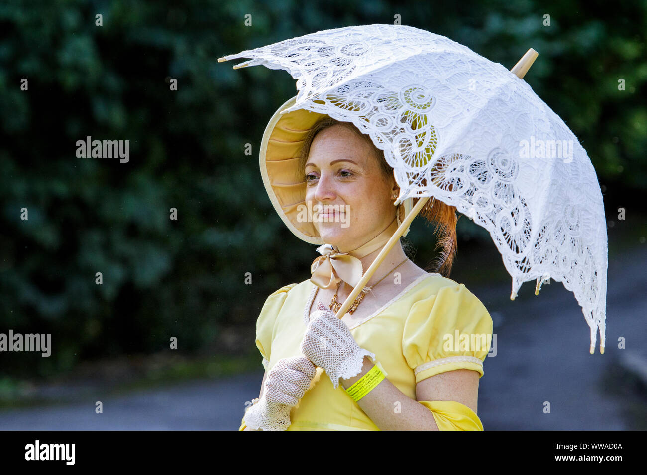 Bath, Somerset, UK. 14th Sep, 2019. A Jane Austen fan taking part in the world famous Grand Regency Costumed Promenade is pictured in Bath's Parade Gardens. The Promenade, part of the 10 day Jane Austen Festival is a procession through the streets of Bath and the participants who come from all over the world dress in 18th Century costume. Credit: lynchpics/Alamy Live News Stock Photo