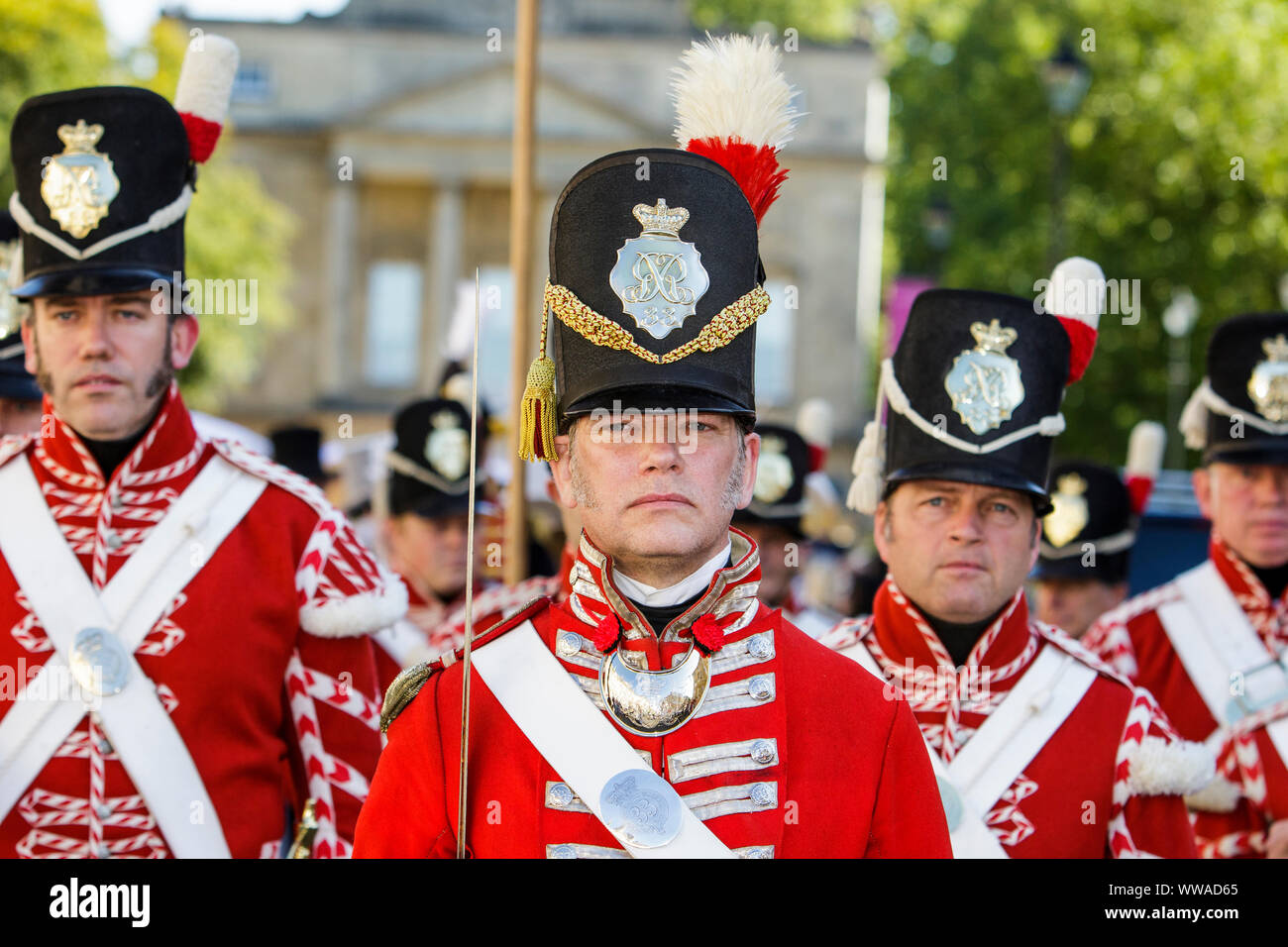 Bath, Somerset, UK. 14th Sep, 2019. Members of the re-enactment group, His Majesty's 33rd Regiment of Foot are pictured marching along Great Pulteney Street as they take part in the world famous Grand Regency Costumed Promenade. The Promenade, part of the 10 day Jane Austen Festival is a procession through the streets of Bath and the participants who come from all over the world dress in 18th Century costume. Credit: lynchpics/Alamy Live News Stock Photo