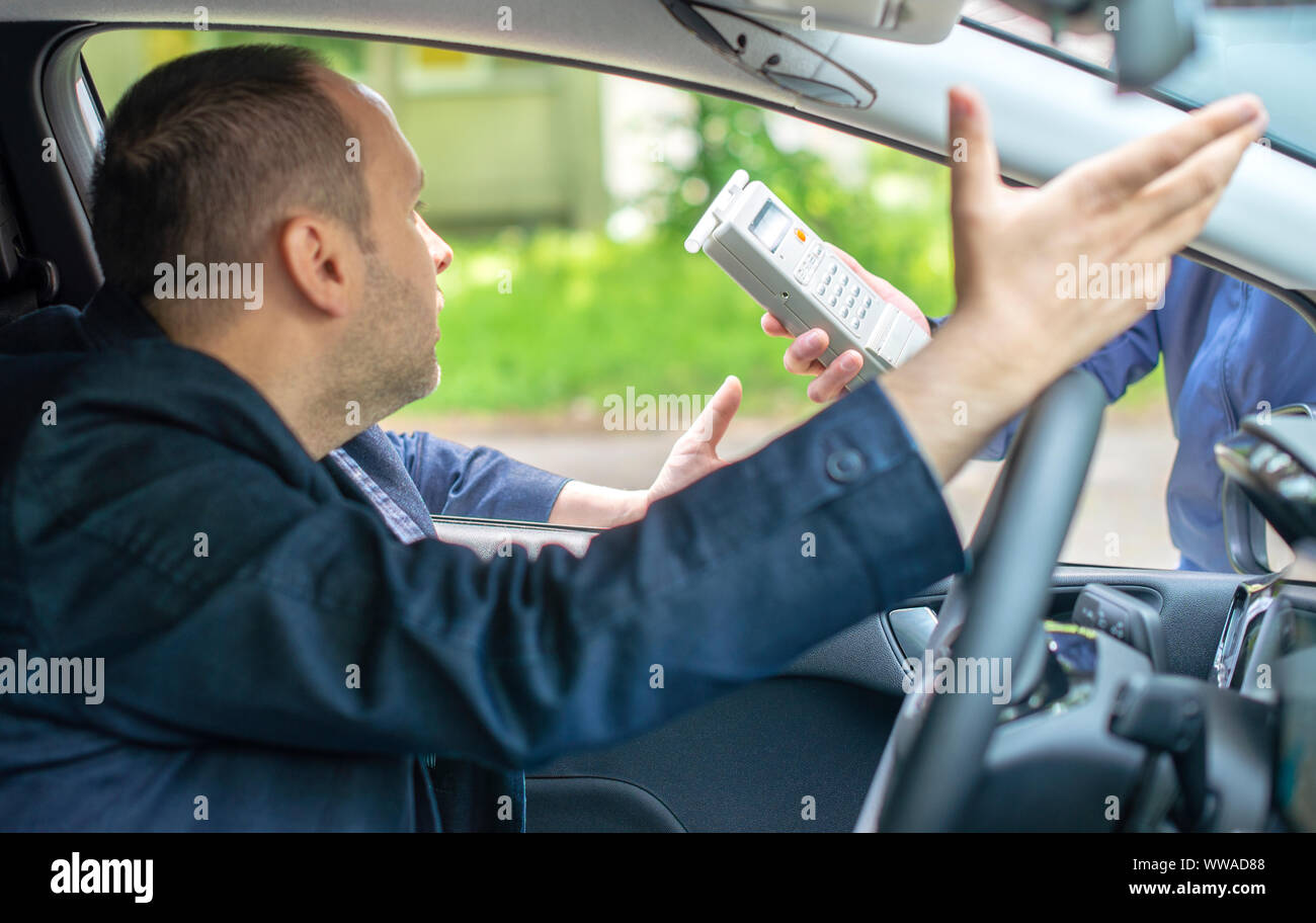 Driver due to being subject to test for alcohol content with use of breathalyzer Stock Photo