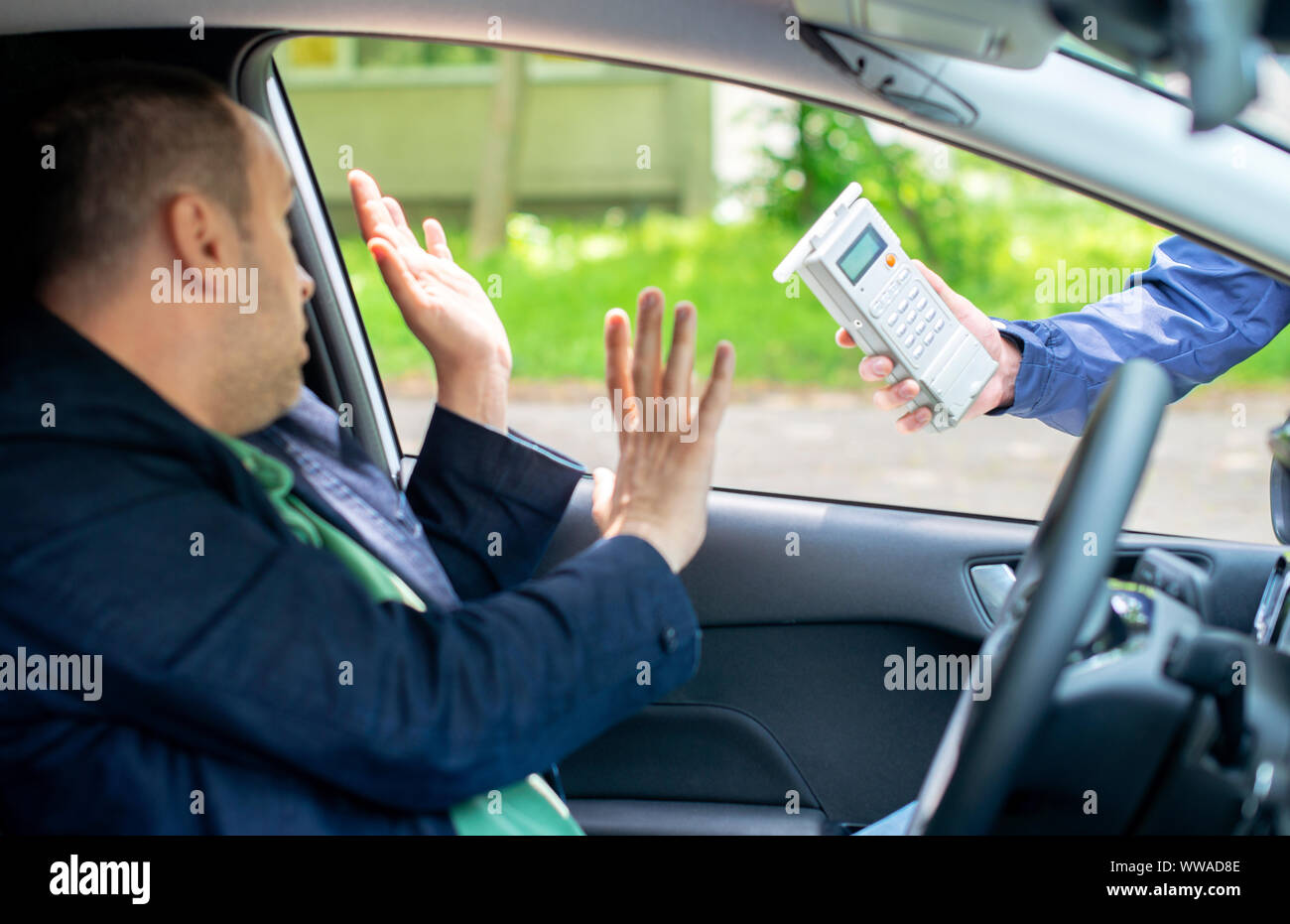 Driver due to being subject to test for alcohol content with use of breathalyzer Stock Photo