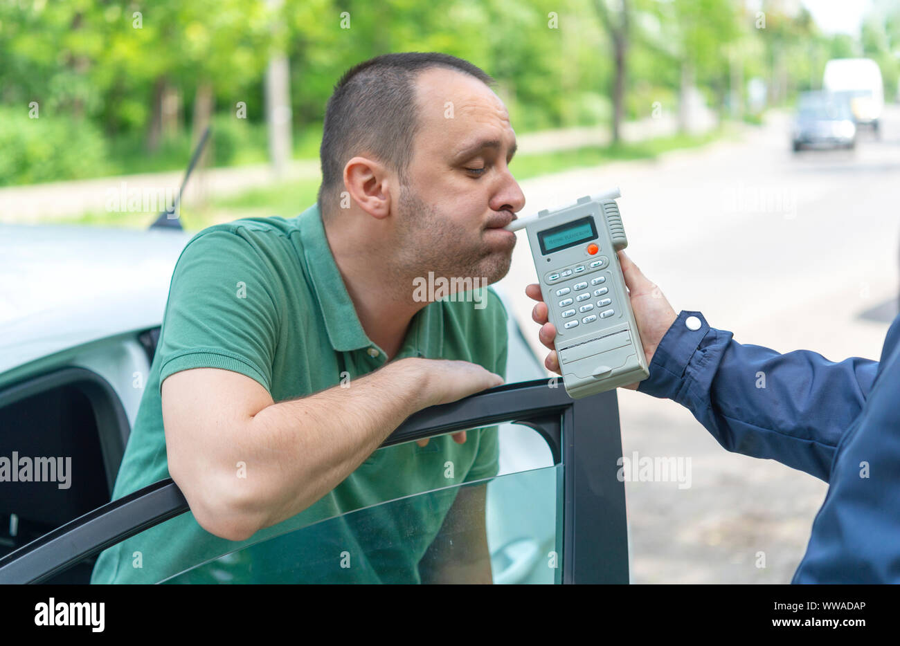 Driver due to being subject to test for alcohol content with use of breathalyzer Stock Photo