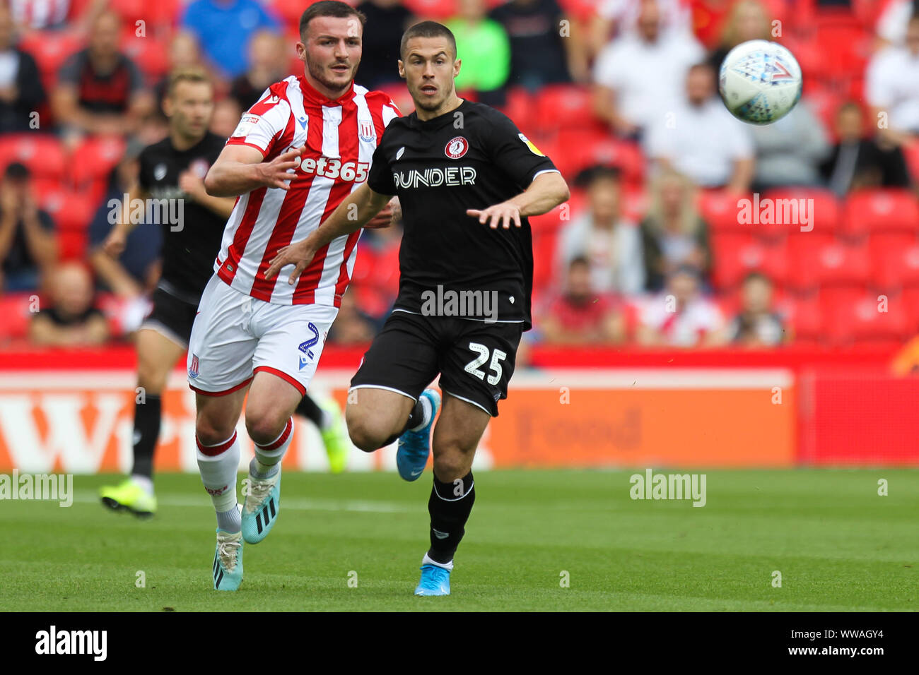 Stoke On Trent, UK. 14th Sep, 2019. Stoke City defender Tom Edwards (2) fights for the ball with Bristol City midfielder Marley Watkins (15) during the EFL Sky Bet Championship match between Stoke City and Bristol City at the bet365 Stadium, Stoke-on-Trent, England on 14 September 2019. Photo by Jurek Biegus. Editorial use only, license required for commercial use. No use in betting, games or a single club/league/player publications. Credit: UK Sports Pics Ltd/Alamy Live News Stock Photo