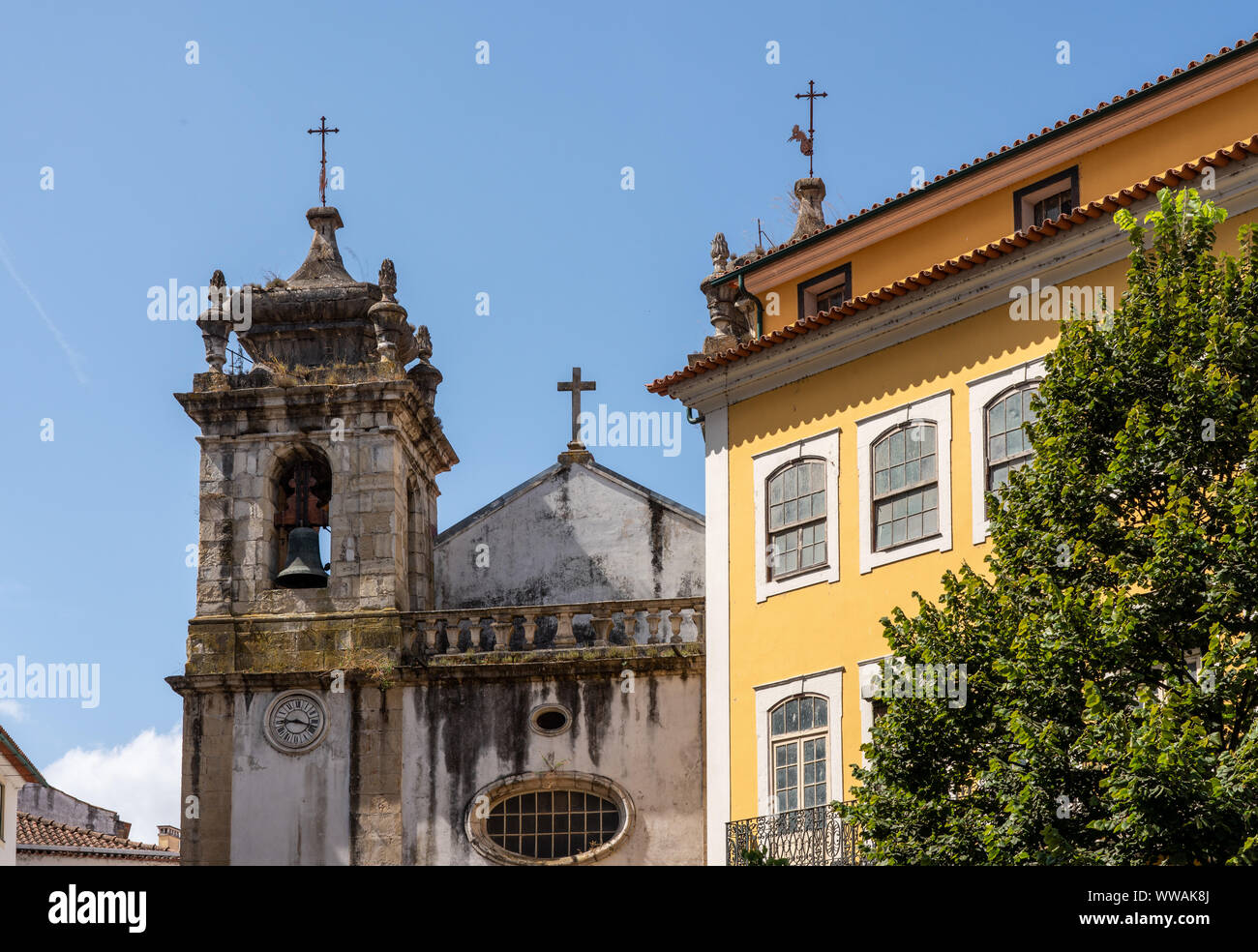 Crumbling bell tower of St Bartholomew church in Coimbra Stock Photo