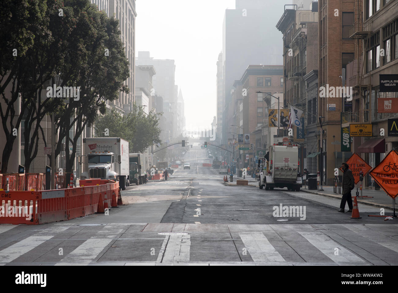 San Francisco, California - November 17, 2018: Roadwork signs and barricades sit on the corner of Market Street and 2nd Street. Stock Photo