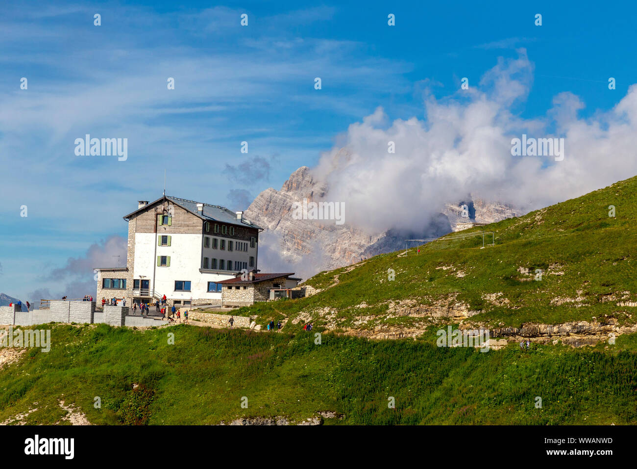 Auronzo alpine hut near the Three Peaks of Lavaredo, in the back Monte Campedelle and Col de le Bisse, Sexten Dolomites Stock Photo