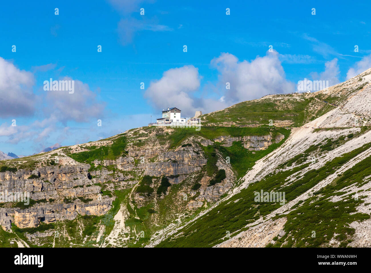 Auronzo alpine hut near the Three Peaks of Lavaredo, in the back Monte Campedelle and Col de le Bisse, Sexten Dolomites Stock Photo
