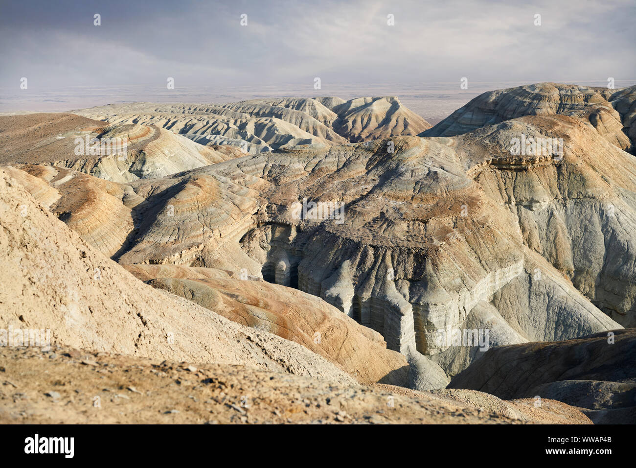 Bizarre layered mountains in the desert park Altyn Emel in Kazakhstan Stock Photo