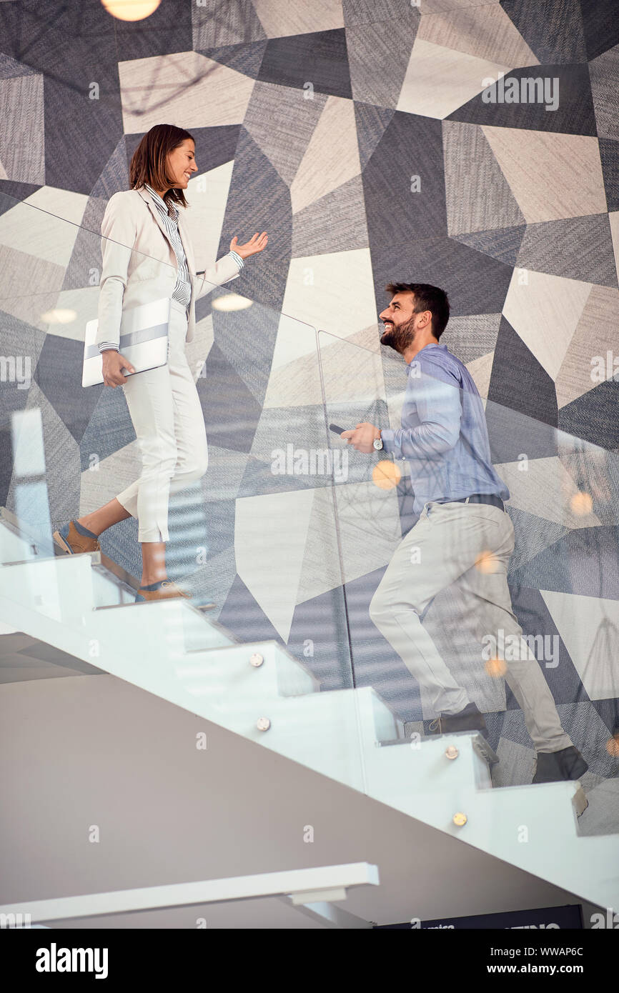 business smiling man and woman walking up the stair Stock Photo - Alamy