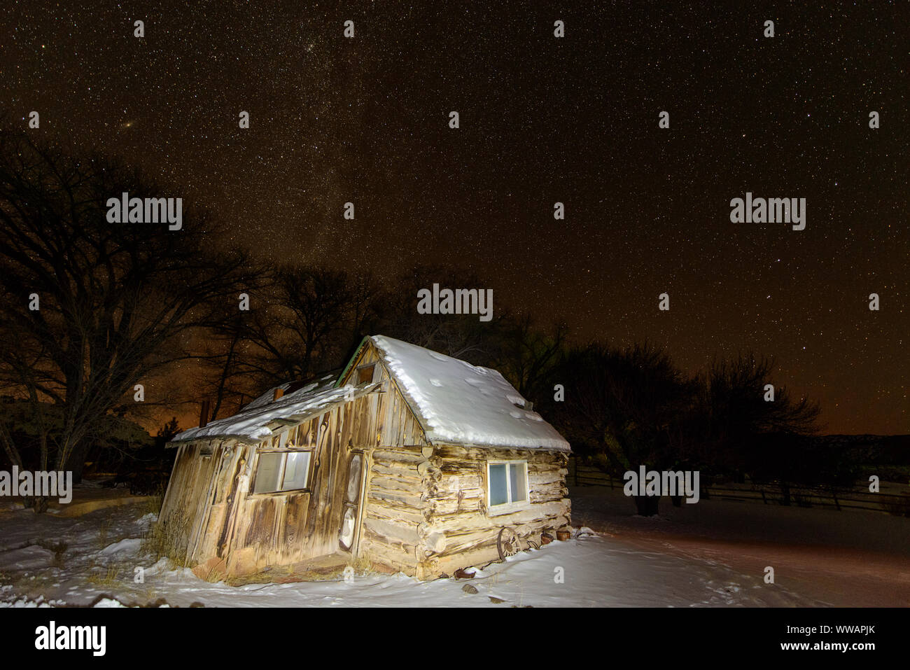 Night sky with old cabin lit by flashlight, Torrey, Utah, USA Stock
