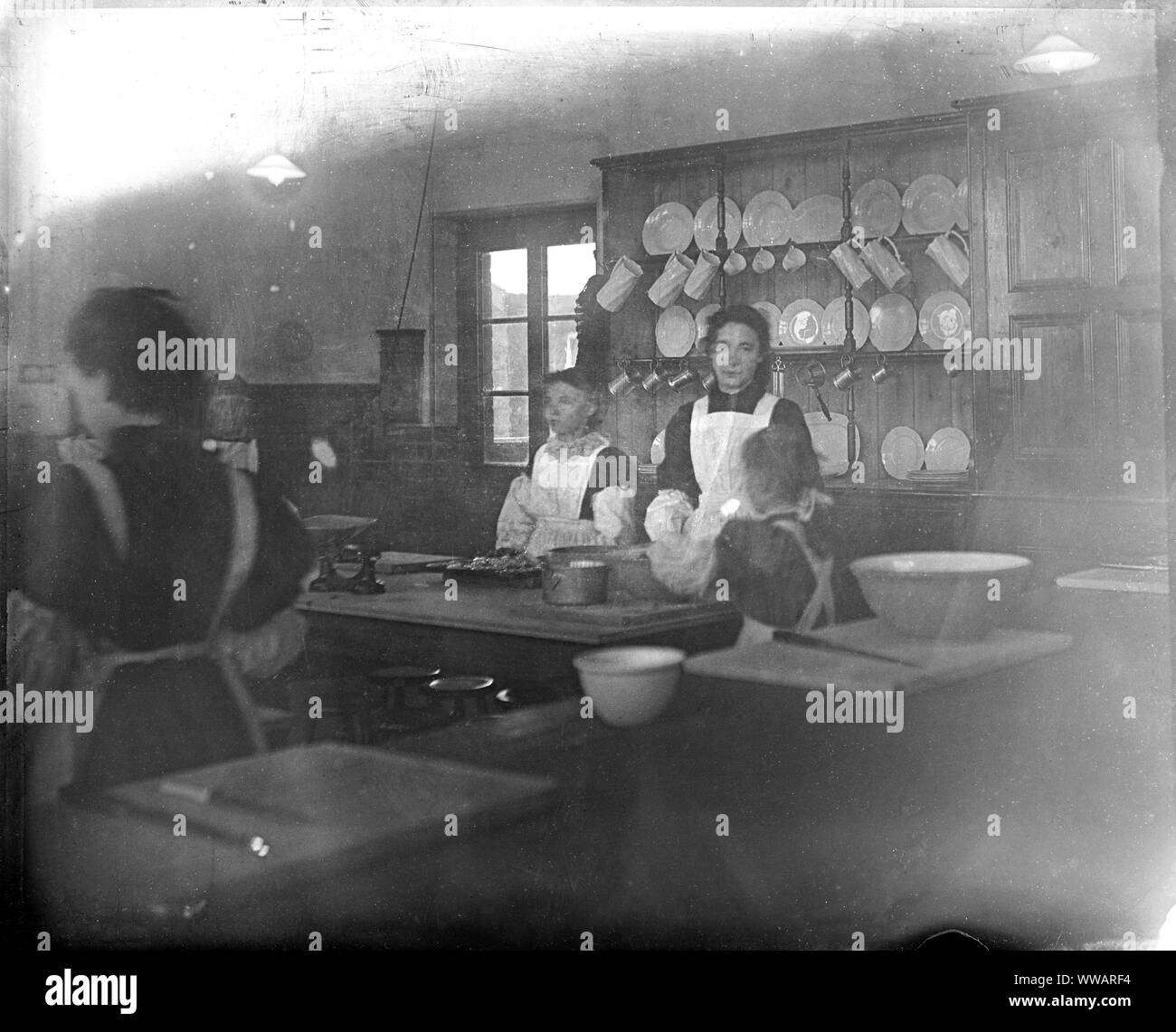Archive image of late Victorian servants working in a kitchen, approximately 1900 Stock Photo