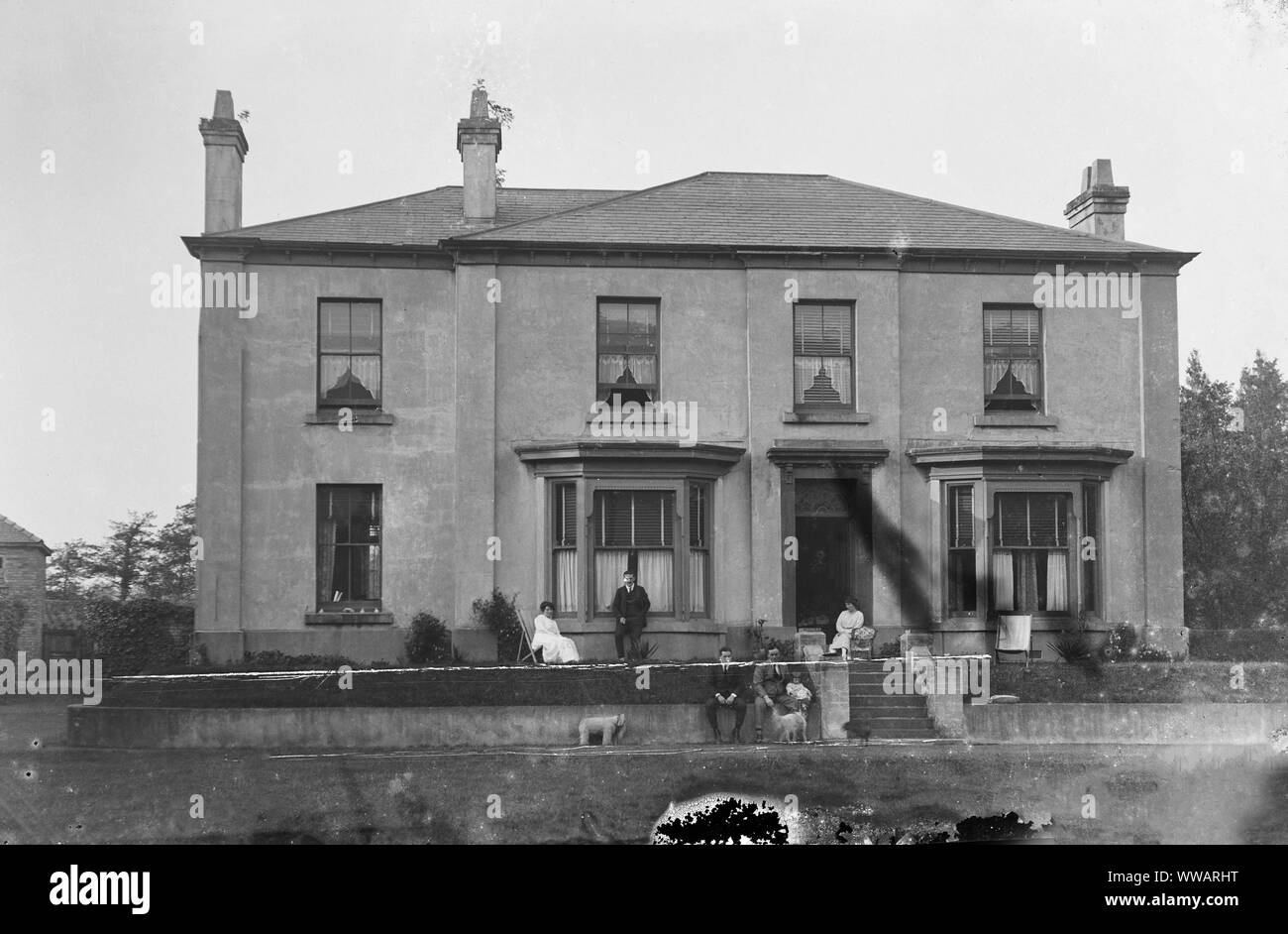 Late Victorian or Edwardian middle class family outside their large home. Scanned directly from glass plate negative. Stock Photo