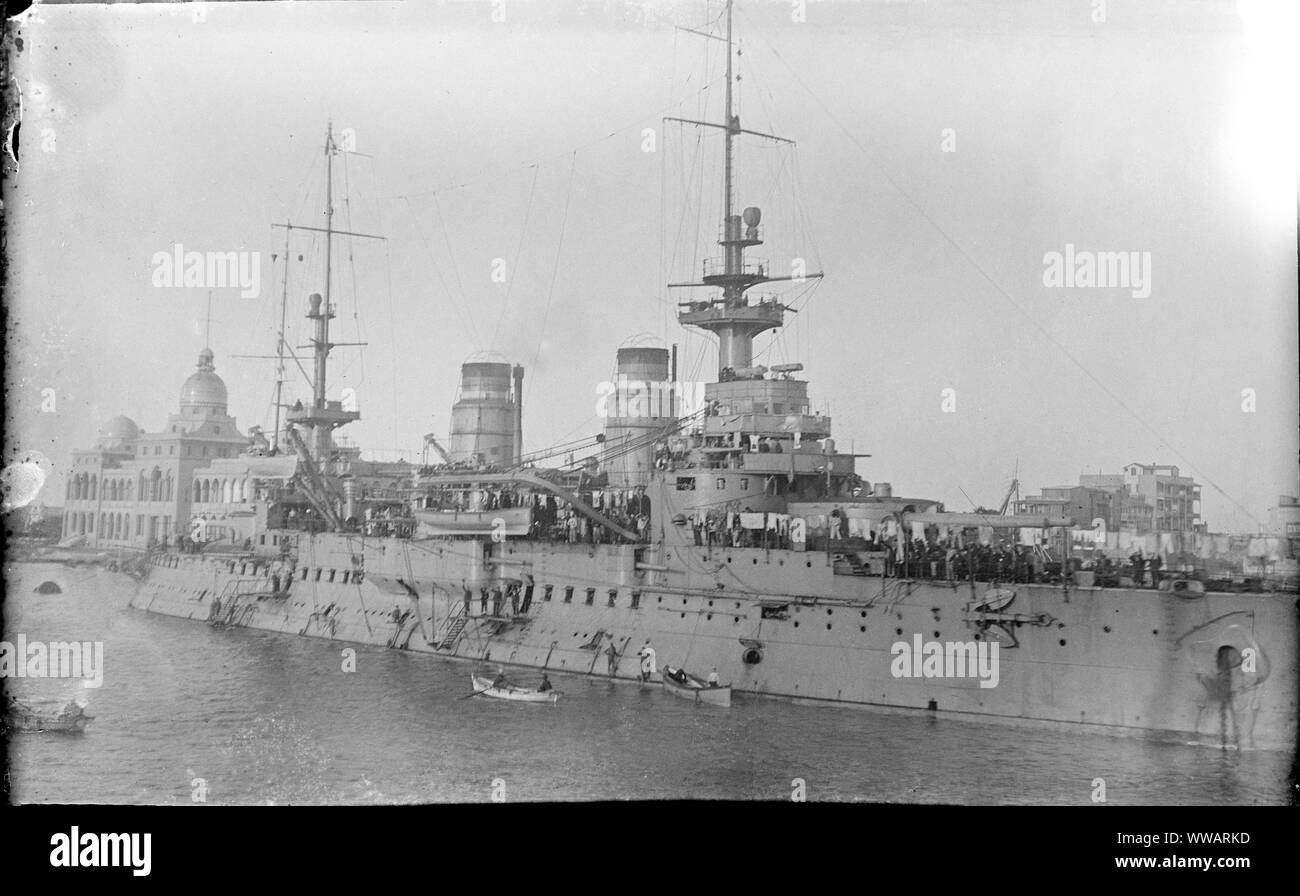 The Saint Louis, a French Navy Charlemagne-class pre-dreadnought battleship docked in Port Said, Egypt in September - November 1914. The Suez Canal Company building can be seen behind. Stock Photo