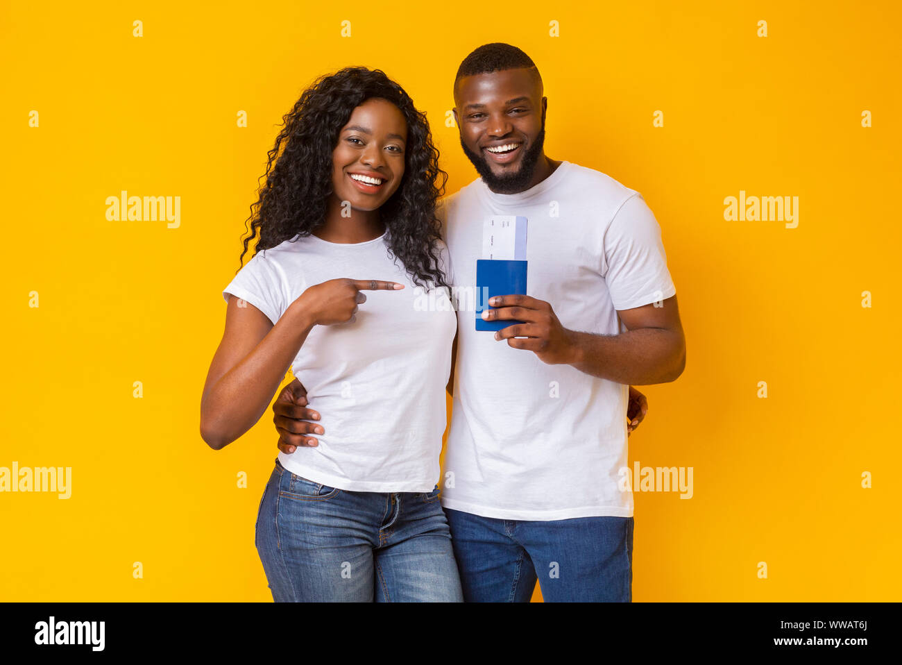 Happy young black couple holding passports and tickets Stock Photo