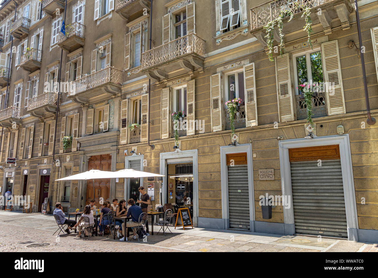 People sitting outside Officine Panino a cafe on Via Carlo Alberto in Turin, Italy Stock Photo