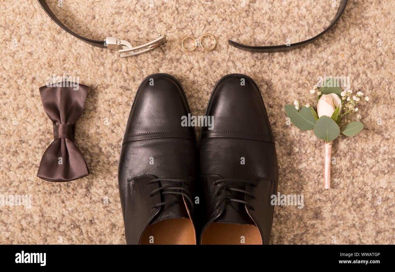 Close up of groom shoes and wedding accessories for him Stock Photo