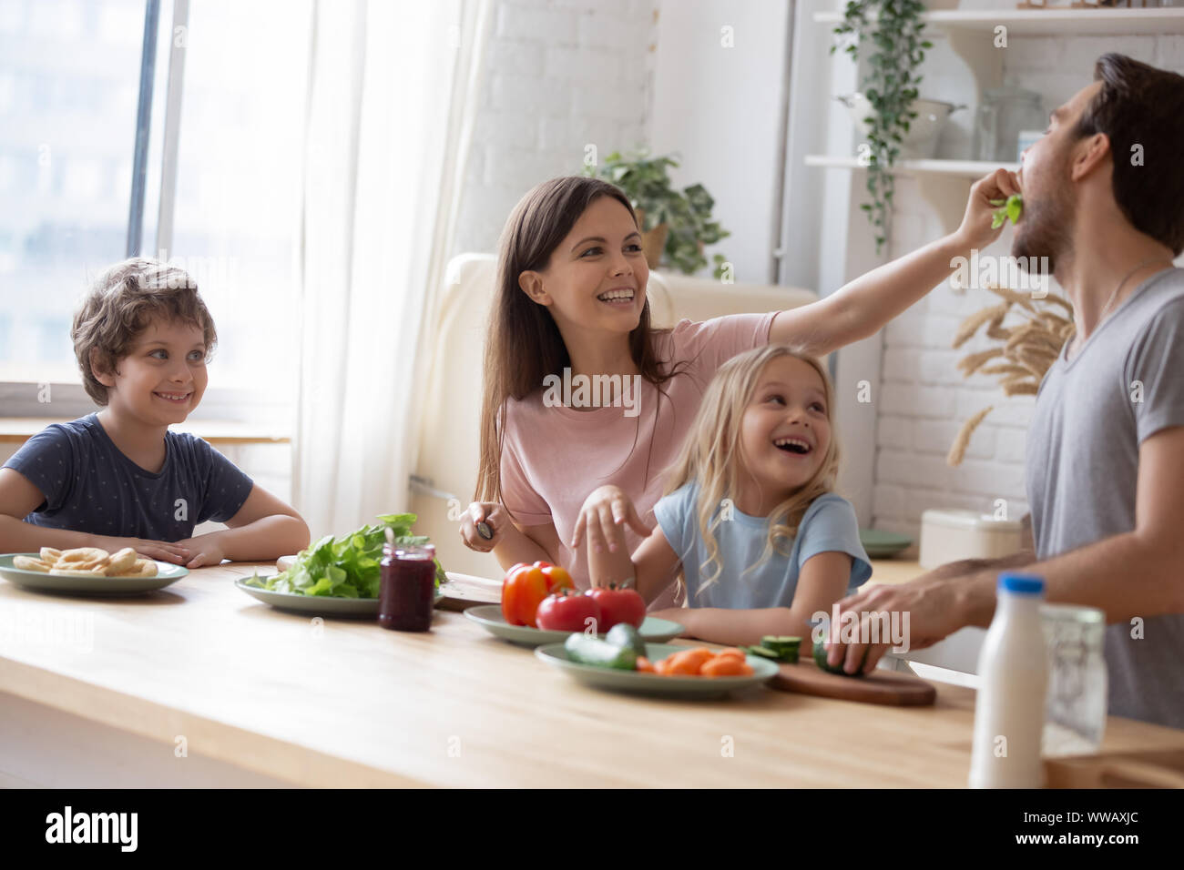 Head shot happy full family sitting at huge kitchen table Stock Photo ...