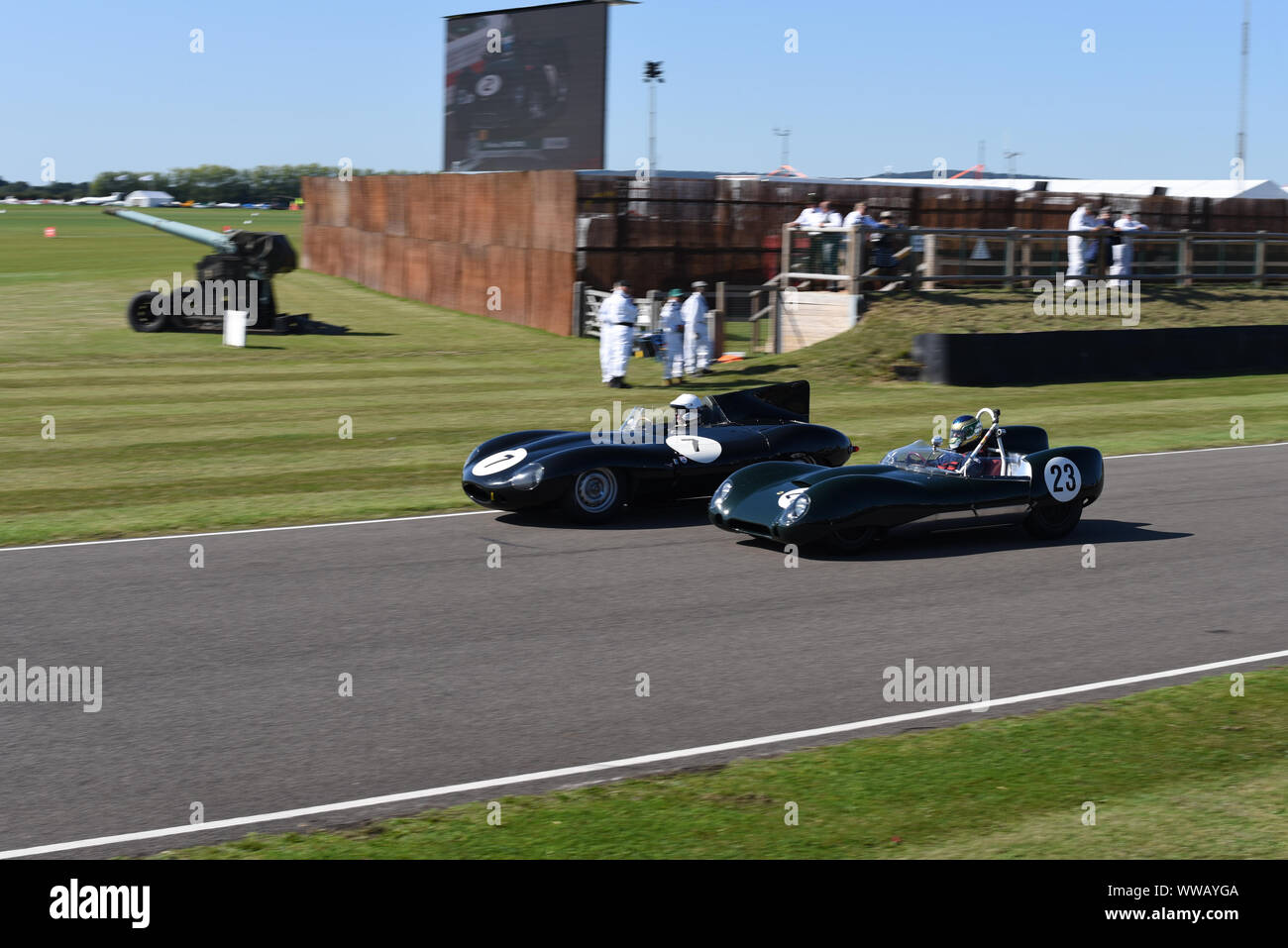 Goodwood Revival 2019 - Sussex Trophy -1955 Jaguar D-type 'long-nose' driven by Gary Pearson battling with 1959 Lotus-Climax 15 driven by Mike Malone Stock Photo