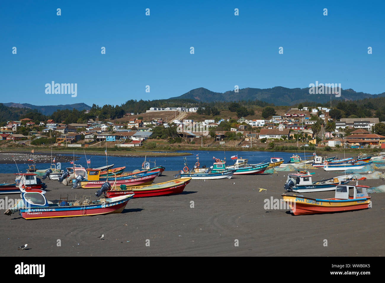 Colourful fishing boats on the beach in the small fishing village of Curanipe in the Maule Region of Chile. Stock Photo
