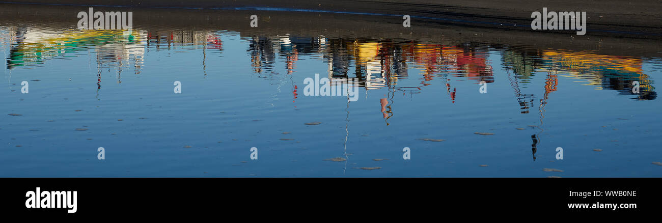 Colourful fishing boats reflected in a river in the small fishing town of Curanipe, Chile. Stock Photo