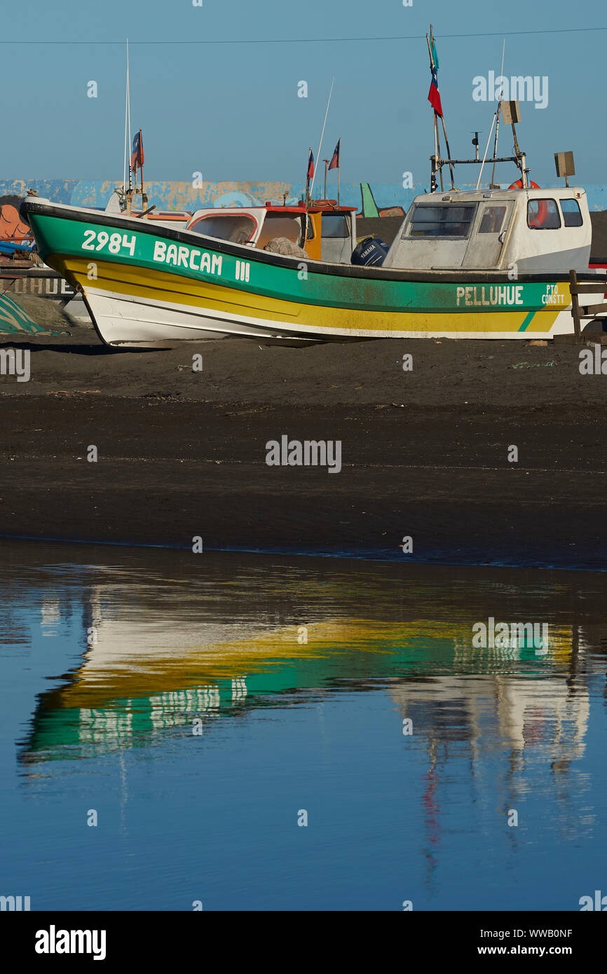 Colourful fishing boats reflected in a river in the small fishing town of Curanipe, Chile. Stock Photo