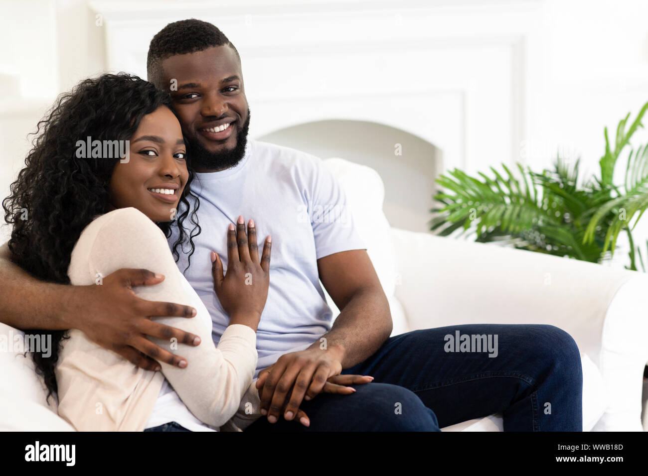 Married couple sitting at home posing to camera Stock Photo