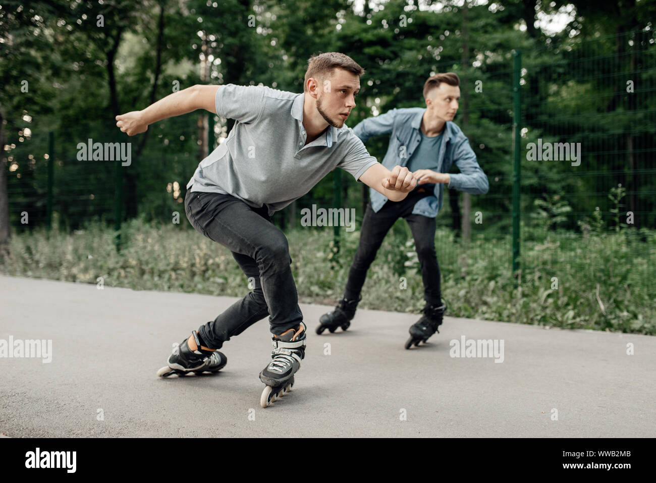 Roller skating, two male skaters begins speed race Stock Photo Alamy