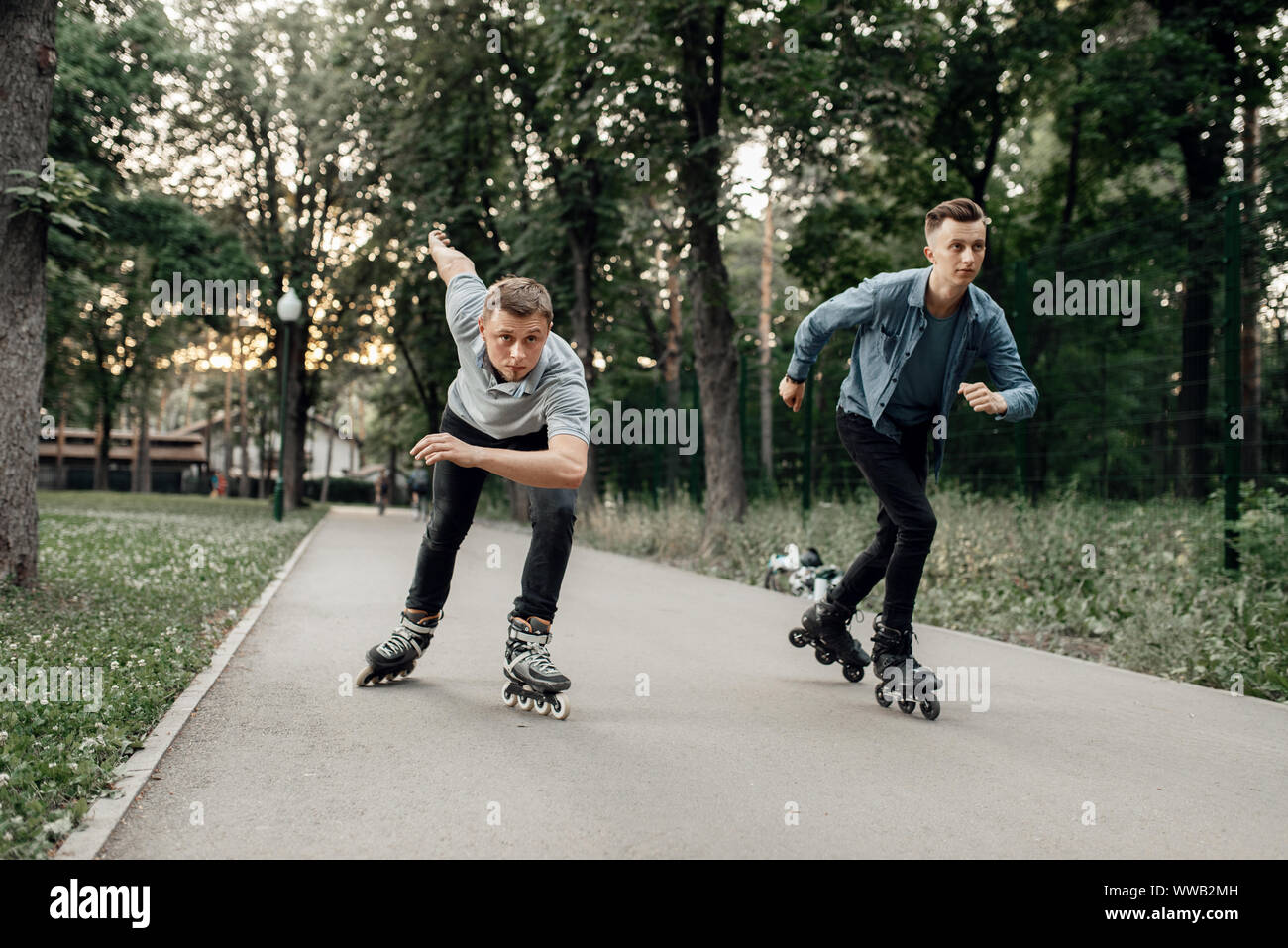 Roller skating, two male skaters begins speed race Stock Photo Alamy