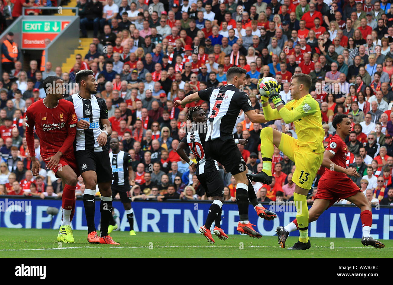 Liverpool, UK.14th September 2019; Anfield, Liverpool, Merseyside, England; English Premier League Football, Liverpool versus Newcastle United; Liverpool goalkeeper Adrian leaps to claim the ball under pressure from Fabian Schar of Newcastle United -