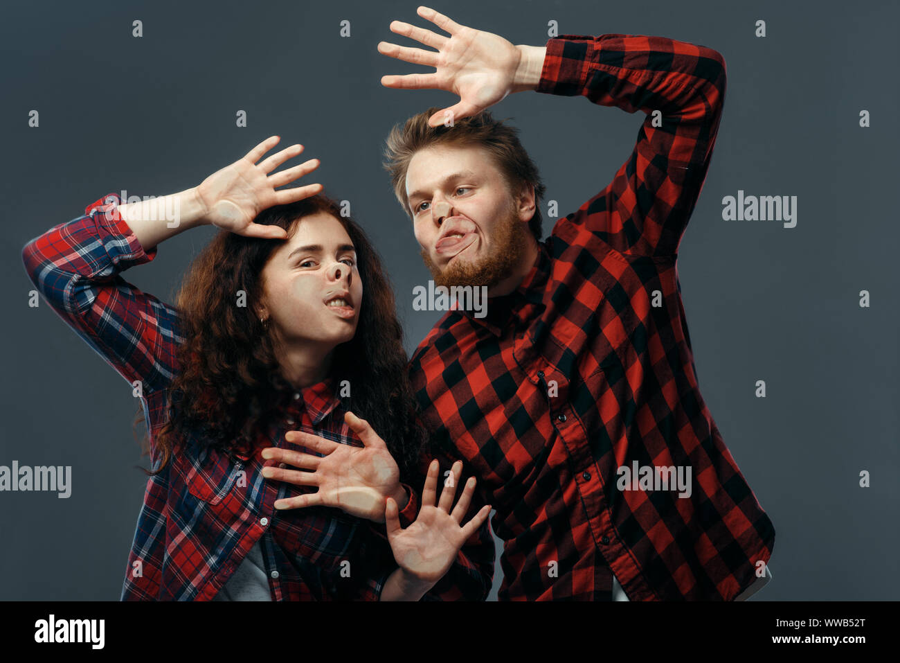 Couple funny faces crushed on transparent glass Stock Photo