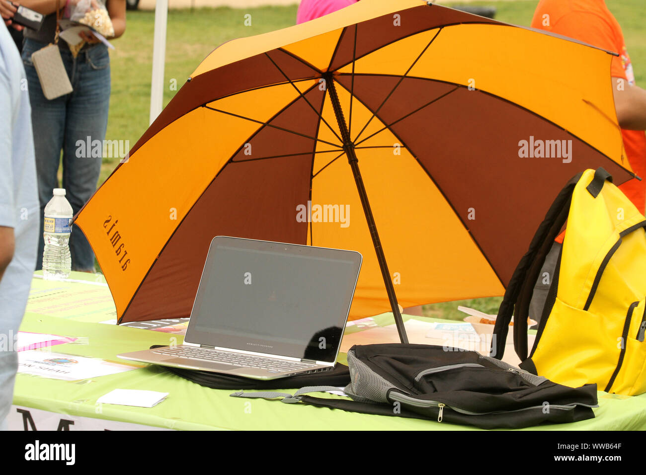 Laptop on the lawn protected from the sun heat with an umbrella Stock