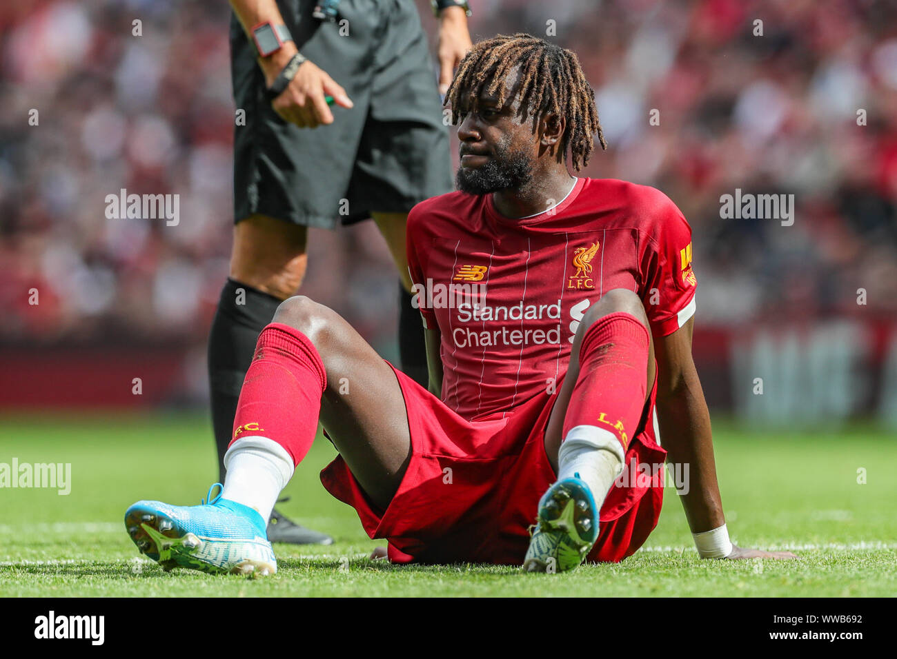 Liverpool, UK. 14th Sep, 2019. Premier League Football, Liverpool vs Newcastle United ; Divock Origi (27) of Liverpool grits his teeth as he sits injured on the floor Credit: Mark Cosgrove/News Images Premier League/EFL Football images are subject to DataCo Licence Credit: News Images /Alamy Live News Stock Photo