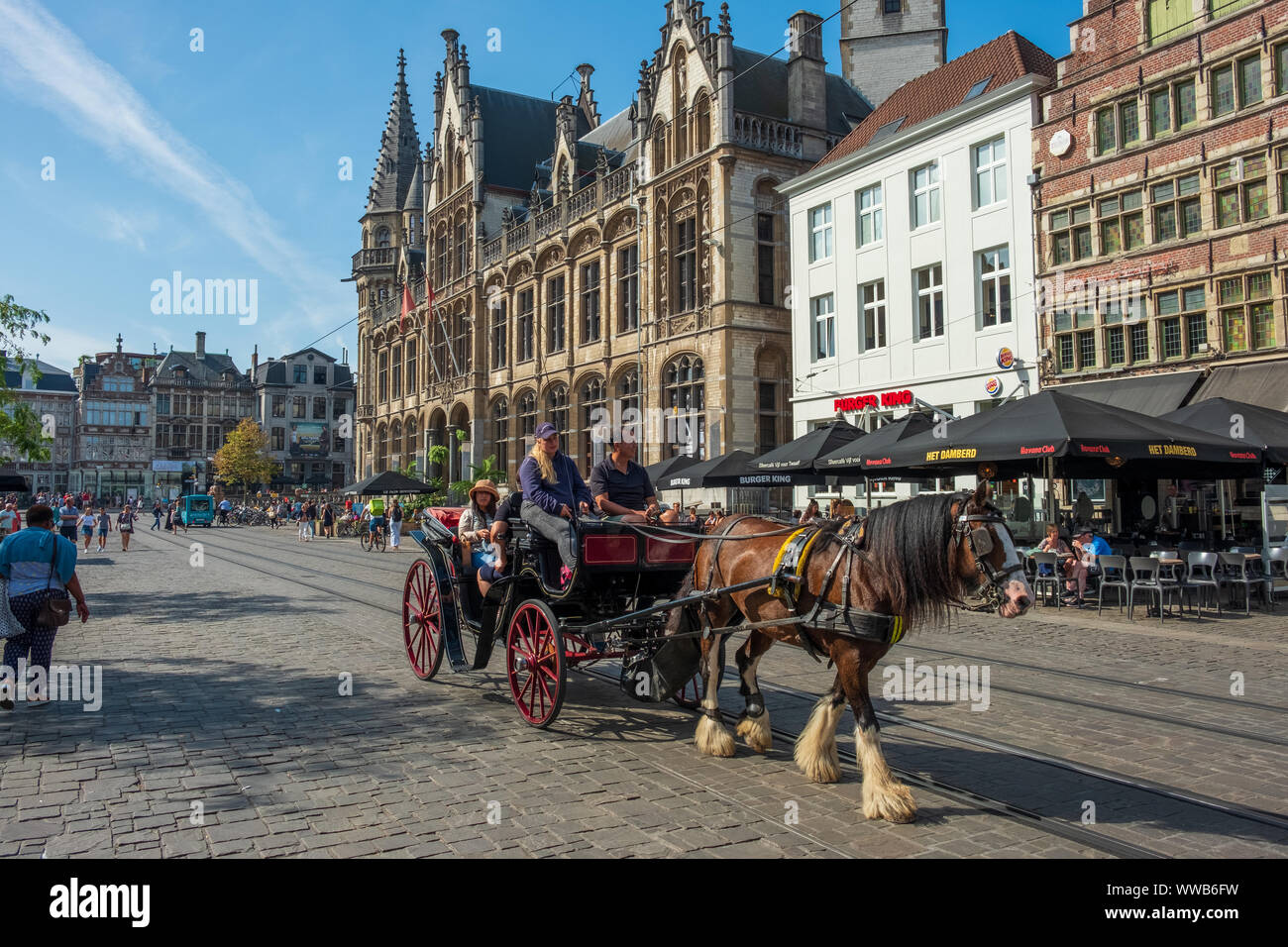 Tourist sightseeing tours by horse drawn coach through center of Ghent Belgium. Historical center of Ghent, Flemish Region, Belgium, EU. Stock Photo