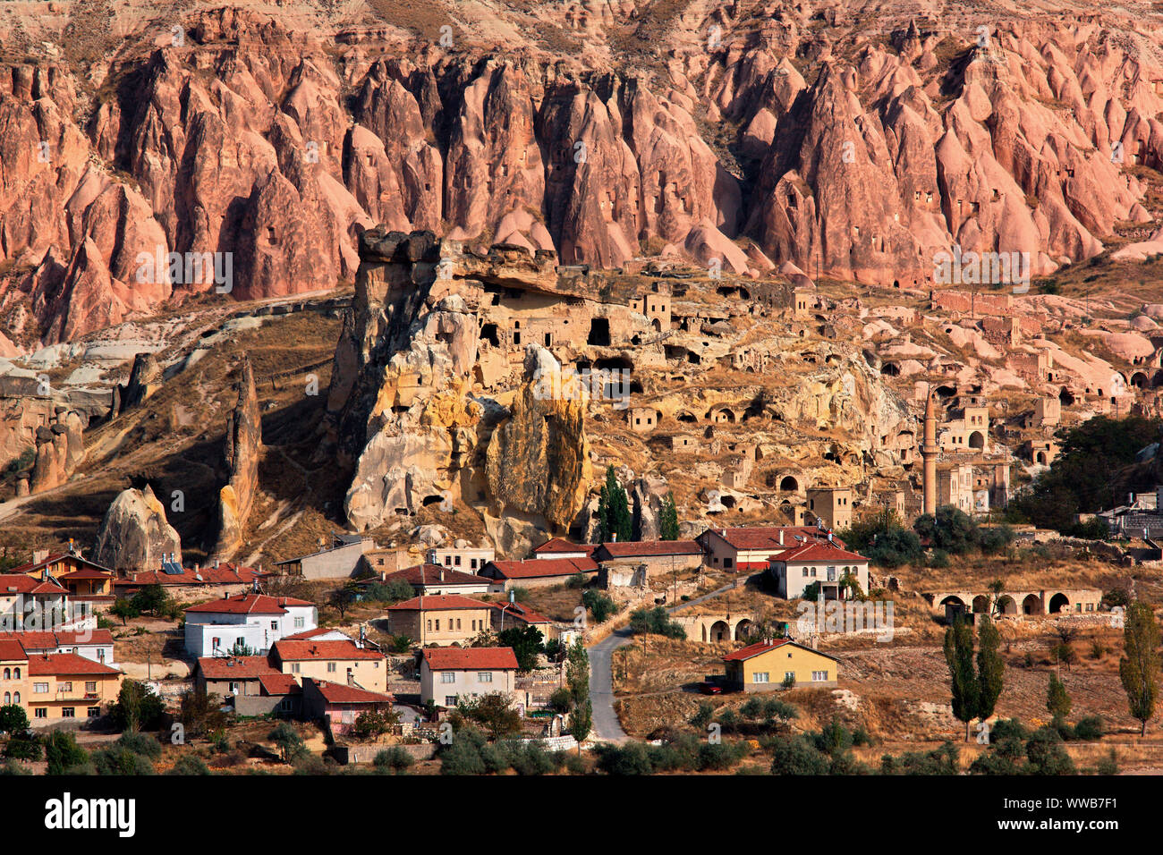 CAPPADOCIA, TURKEY. View of the village and the old troglodyte settlement of Cavusin, where you can see the oldest rock cut church in the region. Stock Photo