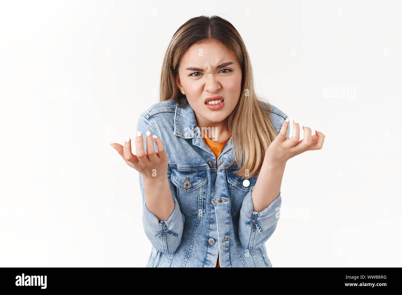Girl swearing cursing cruel unfair life losing chance participate event. Upset intense annoyed hateful asian blond girl cringing grimacing anger Stock Photo
