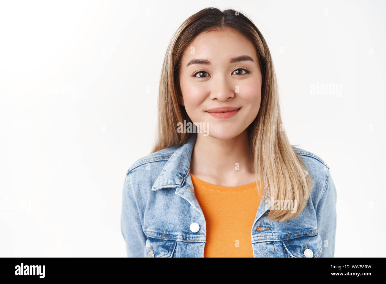 Close-up sweet tender asian blond female student smiling broadly lucky optimistic gaze look forward determined expressed lovely cute emotions standing Stock Photo