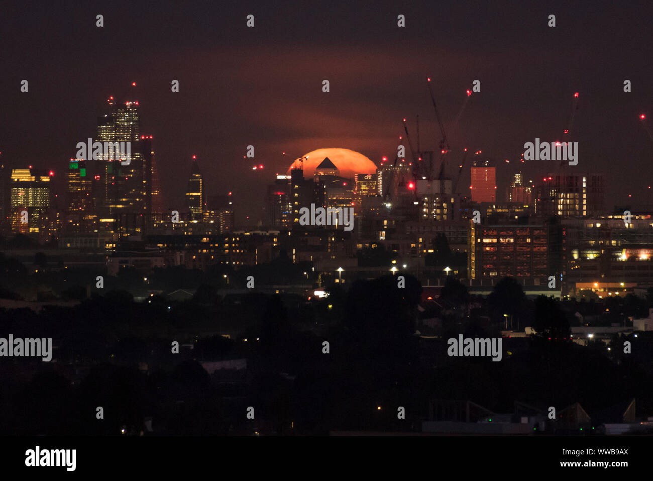 London, UK. 14 September 2019. The full moon rises over the City of ...