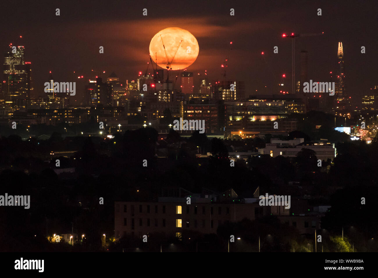 London, UK. 14 September 2019. The full moon rises over the City of ...
