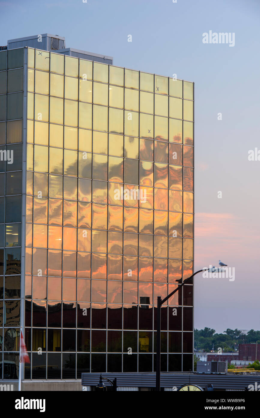 Downtown Sudbury in the evening- reflections in the Scotia Bank building, Greater Sudbury, Ontario, Canada Stock Photo