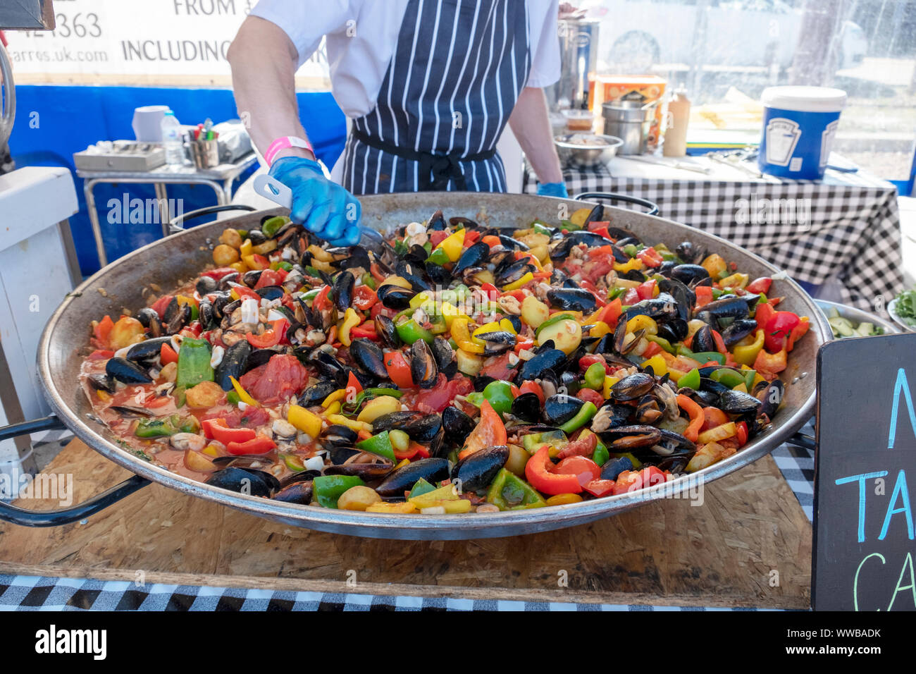 Chefs from Pissaro's restaurant prepare a colourful paella at the annual Hastings Seafood Festival 2019 Stock Photo