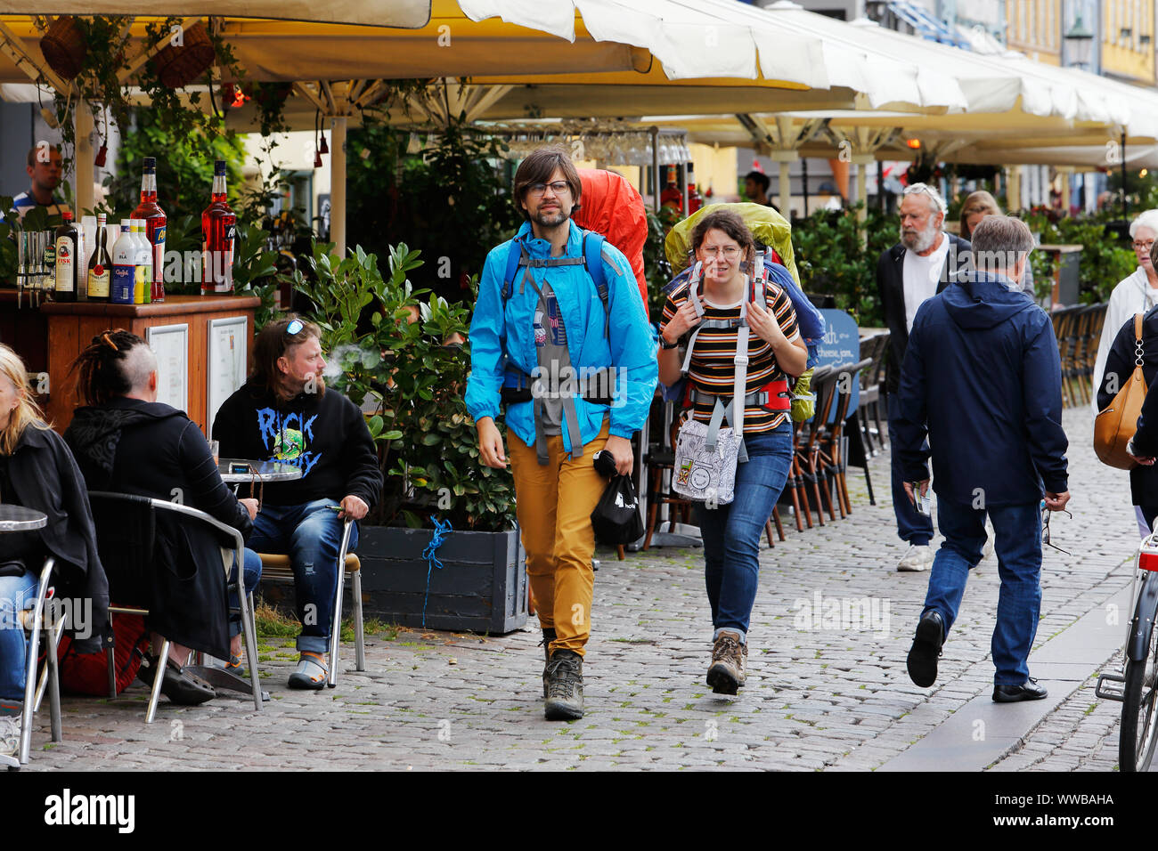 Copenhagen, Denmark - September 4, 2019: Two backpackers walking in the Nyhavn district. Stock Photo