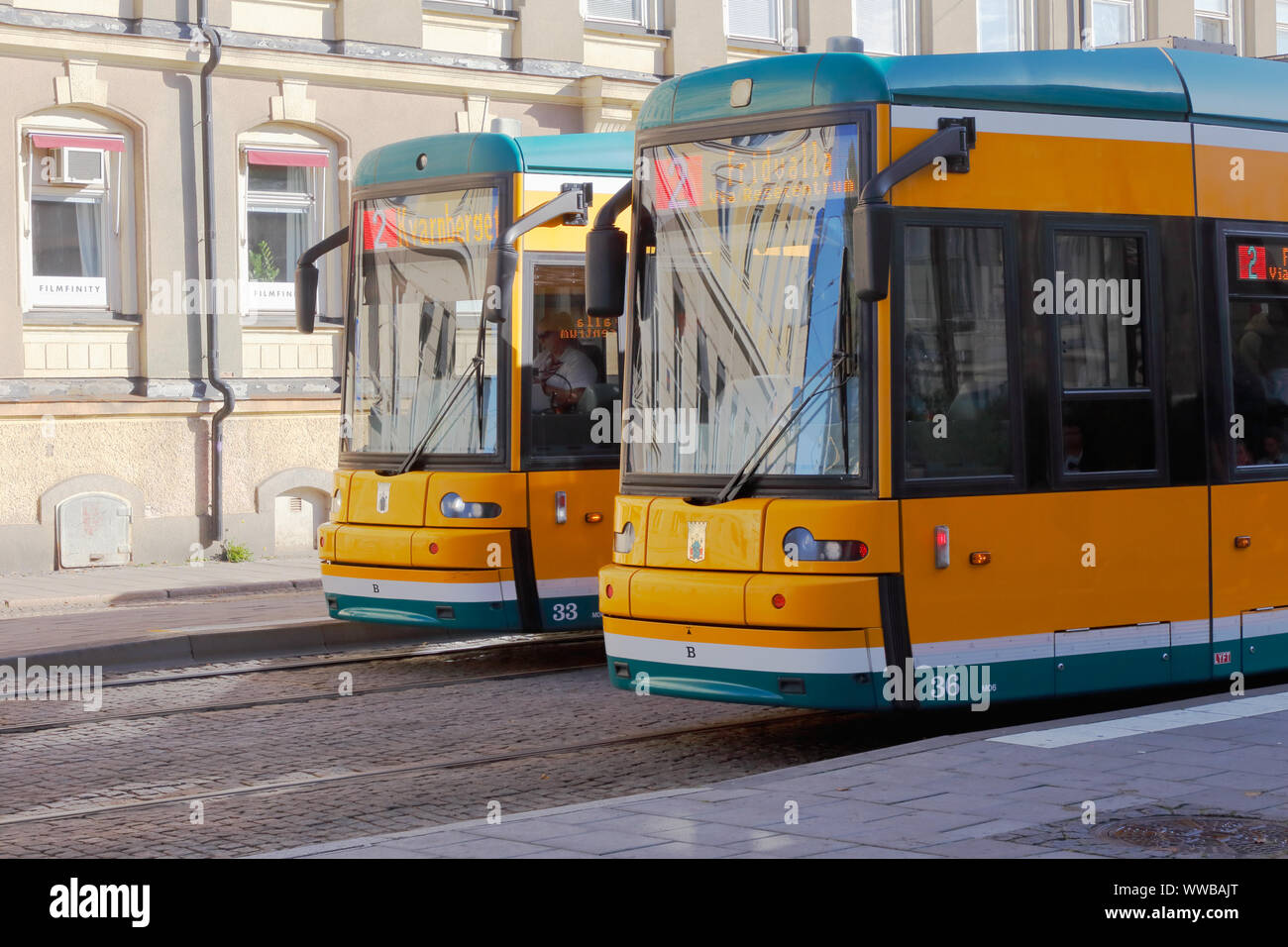 Norrkoping, September 2, 2019: Two yellow trams class M06 in Norrkoping city center in service on line 2. Stock Photo