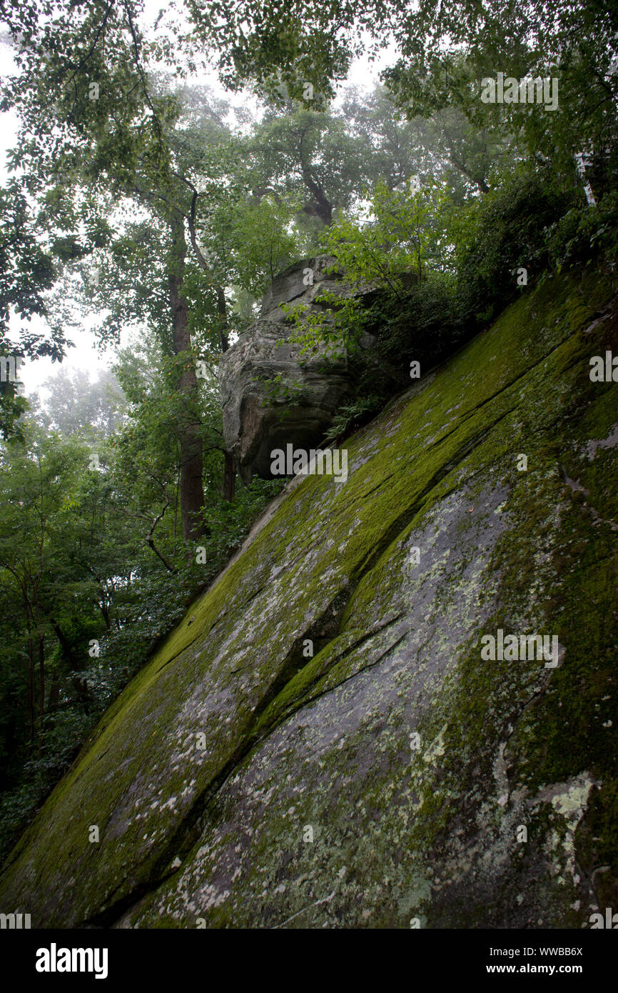 A precariously balanced rock on a cliff in Chimney Rock, North Carolina. Stock Photo