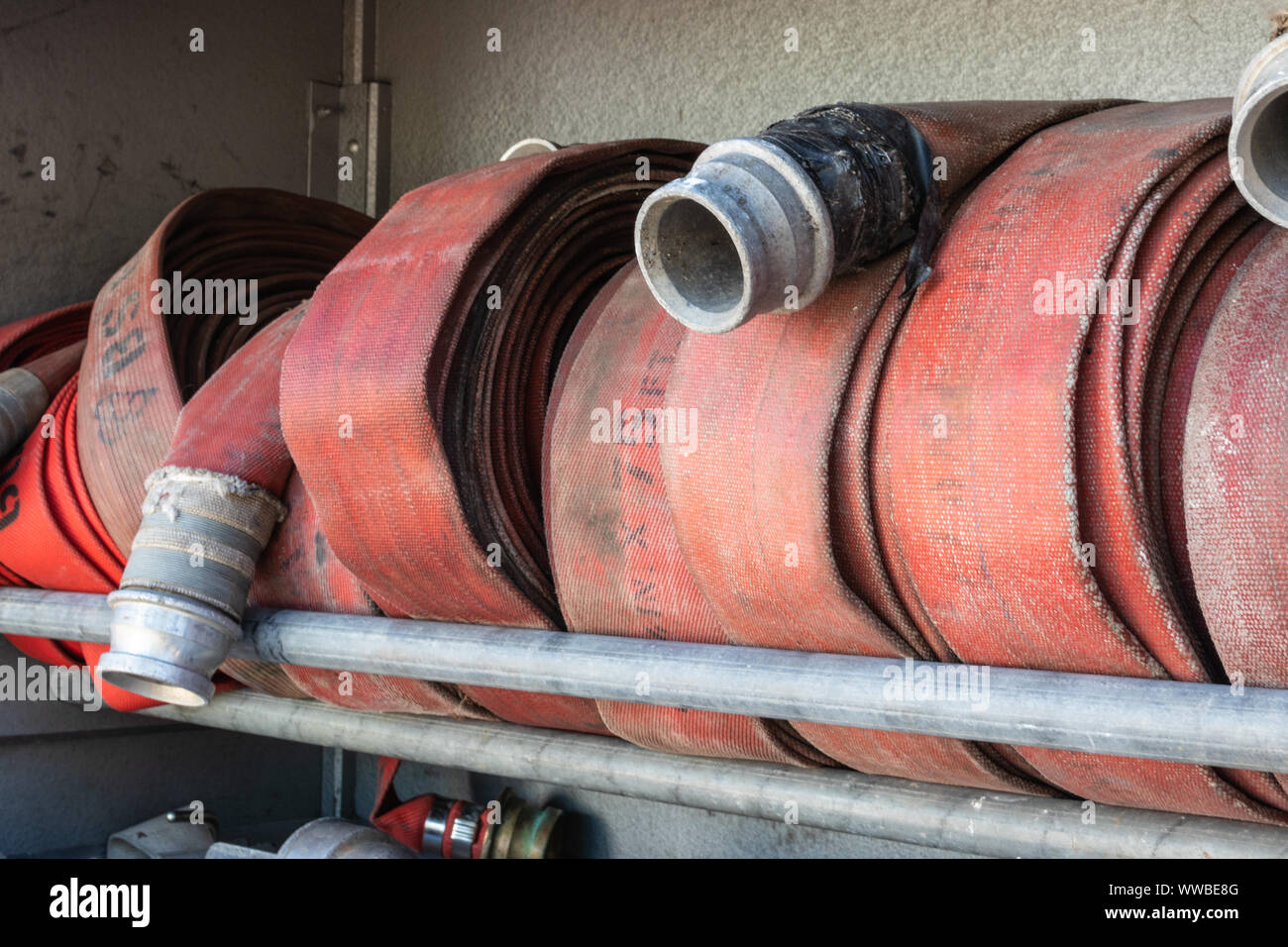 fire hoses coiled in a fire engine Stock Photo