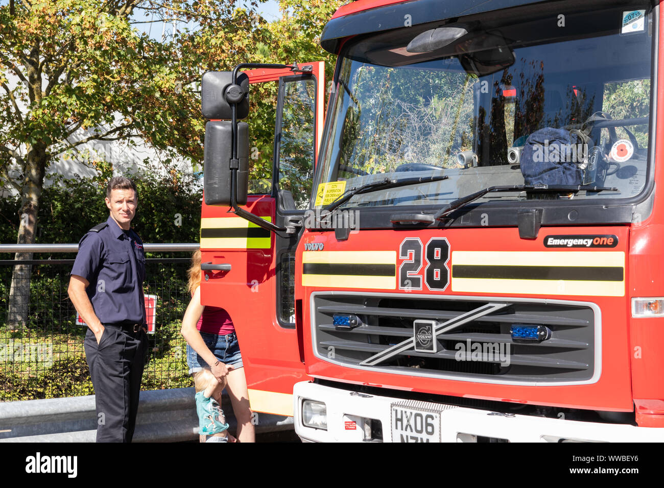 A British Fire engine from Hampshire fire service with a firefighter stood near it Stock Photo