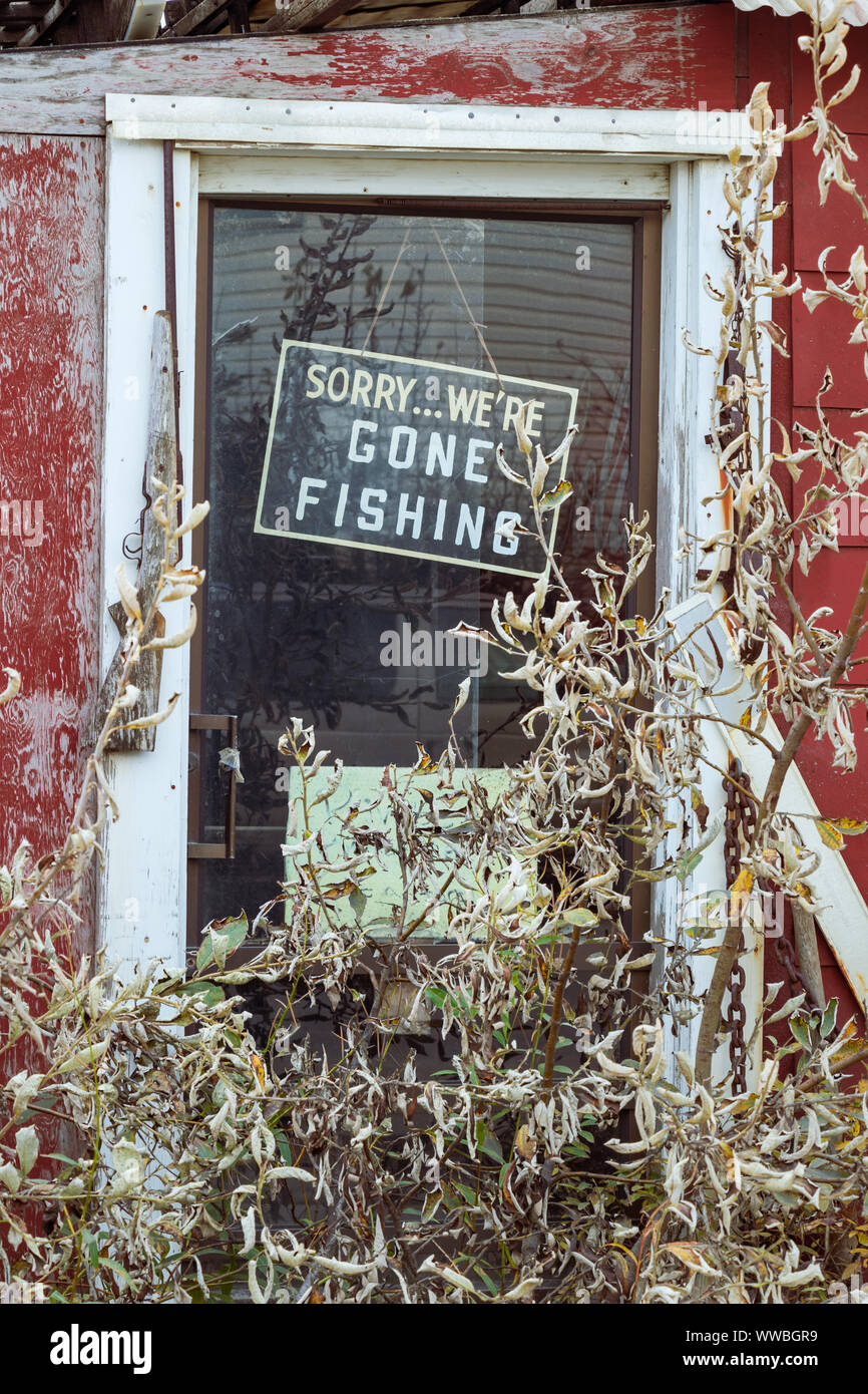 A signboard on a door saying Sorry We Are Gone Fishing in Nome, Alaska. Stock Photo