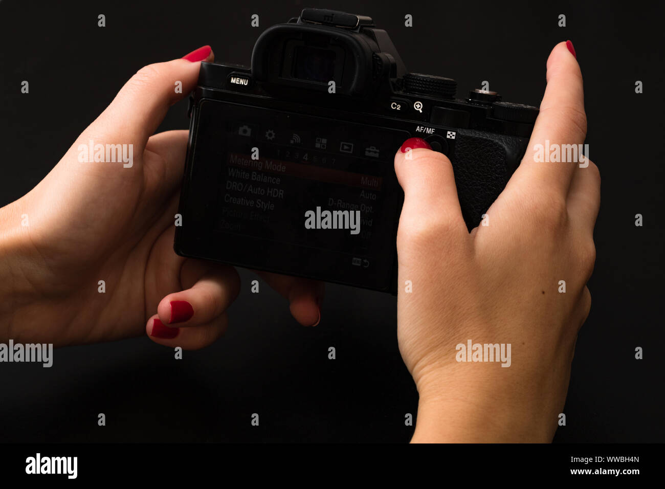 Female hand using photo camera. Close up woman hand on photo camera on ...